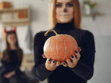 Mother with daughter in a halloween costume and makeup