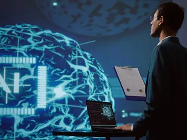 Startup employee looking over business charts, using AI software